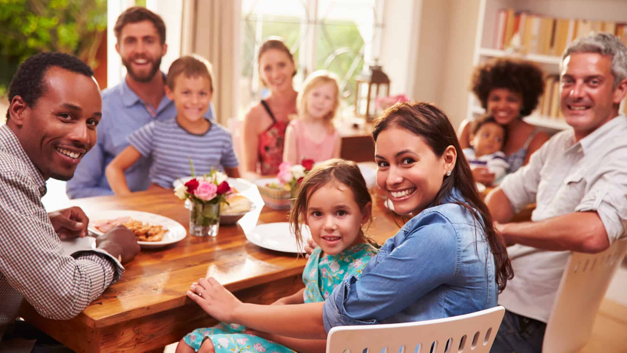 Family around table enjoying a meal