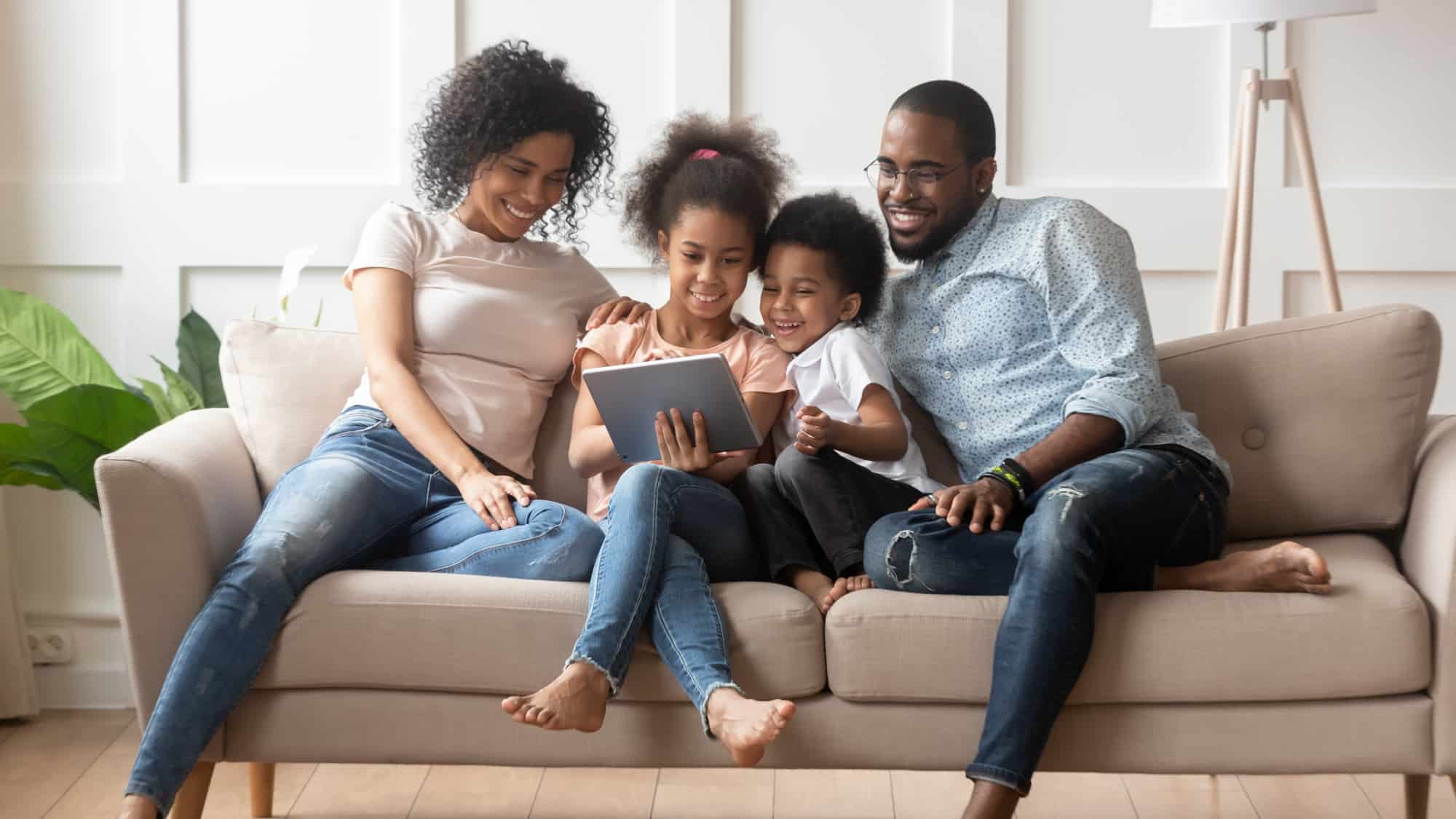 Family on couch looking at computer