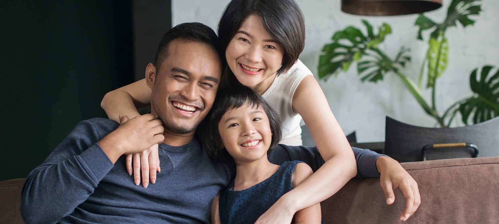 Young happy family on the couch